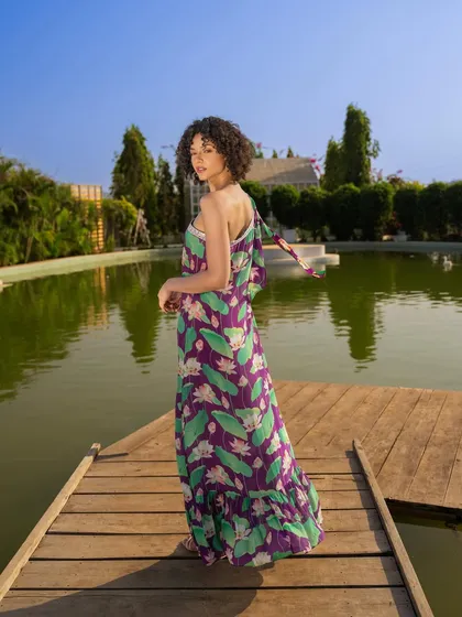 A shot from the same Tangerine Tiger lakeside series. This angle captures the back of the dress and the model looking over her shoulder, adding a sense of story to the campaign.