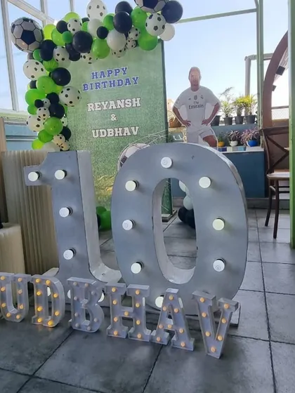 A football-themed joint birthday party for ages 6 and 10, with large marquee numbers and player cutouts.
