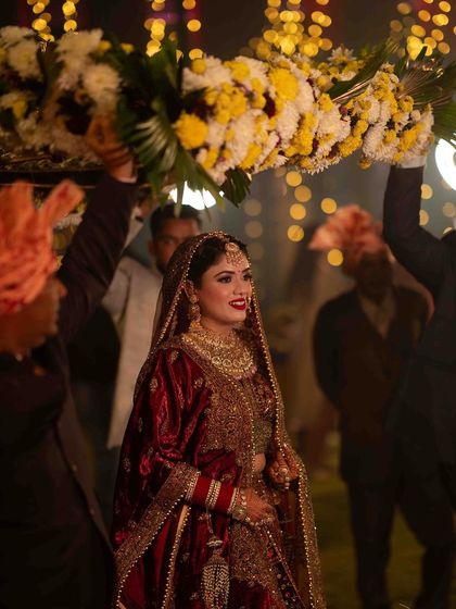 My pretty bride Anjali making her grand entrance. The flowers and lights make the moment so magical, and she looks like a princess.