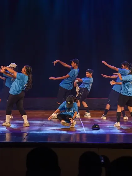 A youth hip-hop crew takes over the stage with attitude and style. This image showcases our expertise in modern dance forms, perfect for a high-energy performance at any event.