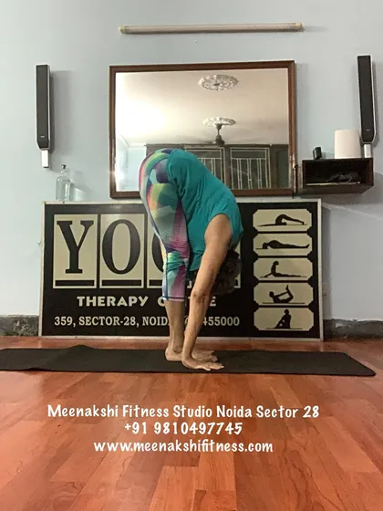 Padahastasana, or hand-under-foot pose. This deep forward bend is a wonderful way to release the spine and stretch the hamstrings.