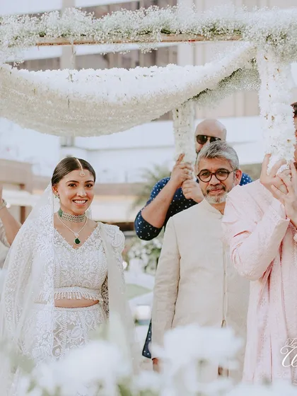 The bride's beautiful smile as she walks down the aisle, surrounded by her family. It's a moment filled with emotion, pride, and happiness.