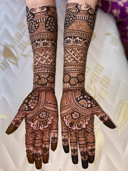 This design features peacocks at the top of the arms, with the rest of the space filled with beautiful floral bands and traditional patterns.