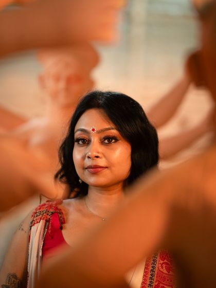 A beautiful close-up capturing the essence of the festive look. The glowing skin, sharp winged liner, and traditional bindi create a look that is both classic and perfectly suited for a modern photoshoot.