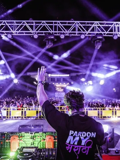 Waving to the massive crowd at a campus festival. The 'Pardon My मराठी' on my shirt is a proud nod to my roots, no matter how big the stage is.