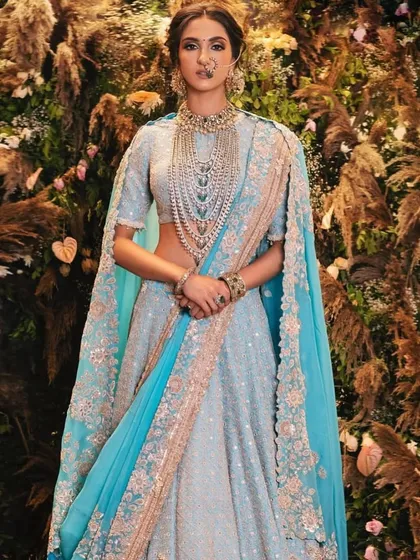 This look is all about dreamy elegance. The light blue lehenga is complemented by a soft, ethereal makeup look with a focus on luminous skin and subtly defined eyes, perfect for a daytime wedding or a sophisticated reception.