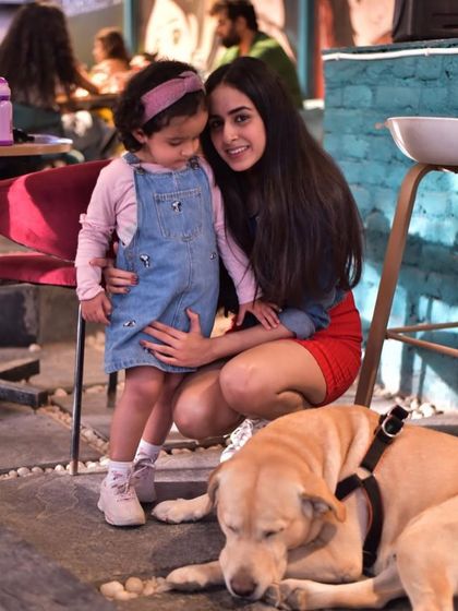 A sweet moment between a little girl and our resident Labrador, Bunny. We love fostering these gentle interactions.