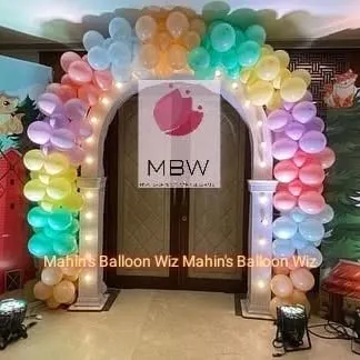 A whimsical pastel balloon arch over a doorway, creating a magical entrance for a themed birthday party.