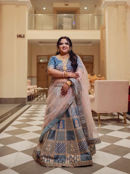Another shot of my bride's stunning reception look. The blue lehenga and soft pink dupatta are complemented by a bold eye and glowing skin, perfect for post-wedding celebrations.