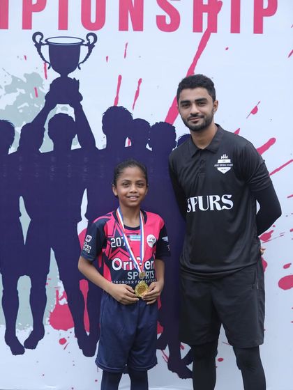 A young player receiving her medal, a proud moment from the championship.