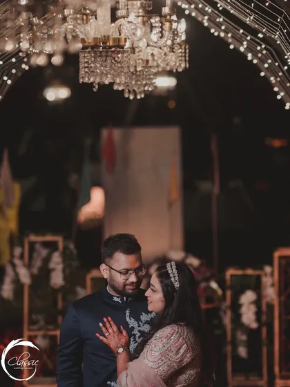 A romantic portrait of the couple, framed by the light-strung archway of the entrance tunnel. This shows how decor can also serve as a beautiful, intimate photo opportunity.