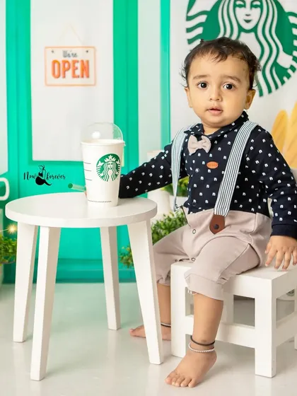Our little barista is ready to take your order! This Starbucks-themed sitter session is a perfect example of how we can turn a fun idea into an adorable and unique photoshoot.