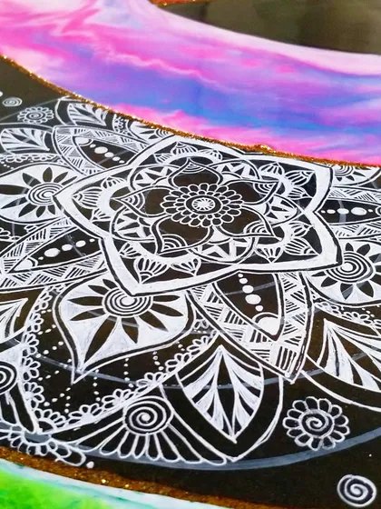 I love combining different techniques. Here, you can see my detailed black and white doodle work layered on top of a vibrant, colorful resin background. This mix of styles creates a striking contrast and a truly unique piece of art.