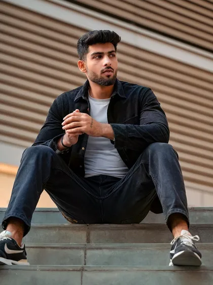 Another angle from the urban staircase shoot, showing a different seated pose. We ensure a variety of shots to build a comprehensive portfolio.