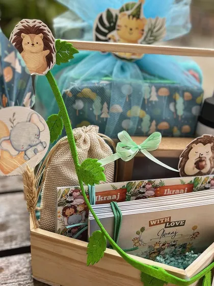 A look at the curated items inside the jungle hamper, including themed books and a personalized water bottle.