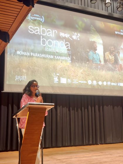 Patricia Loison, Director of Alliance Française de Delhi, addresses the audience at a film premiere. Our leadership is actively involved in creating a welcoming and enriching cultural experience for our guests.