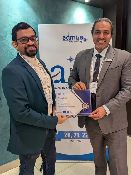 Receiving a certificate of appreciation for being an invited faculty member at the AIM 2025 conference in Chennai.