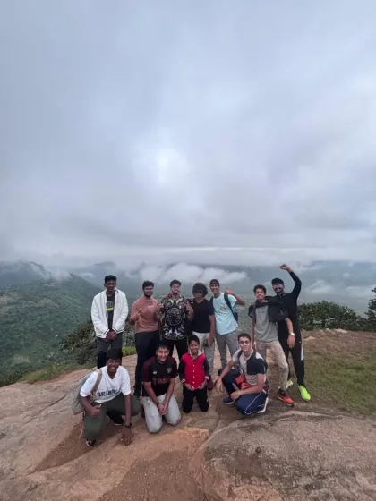 An energetic group of college students celebrating at the top of Kabbaldurga. Our college treks are all about building camaraderie and leadership skills through shared challenges.