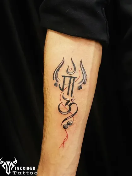 We designed this piece to integrate the word 'Maa' (Mother) into a Trishul and Om symbol, adorned with a Rudraksha. It’s a unique tattoo that honors both maternal and divine energy.