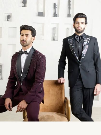 A study in contrasts and complements. This image displays two of my signature formal looks: a wine-colored tuxedo with silk lapels and a black tuxedo with intricate hand-kardana work, showcasing my range in luxury eveningwear.