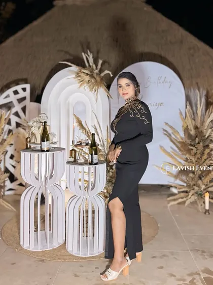 The birthday girl looking elegant against the custom boho backdrop we created for her special night.