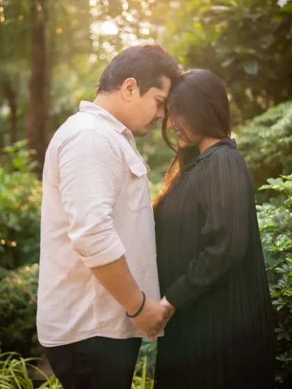 A quiet and intimate moment between the expecting couple. This pose, with foreheads touching, is perfect for capturing their deep connection.