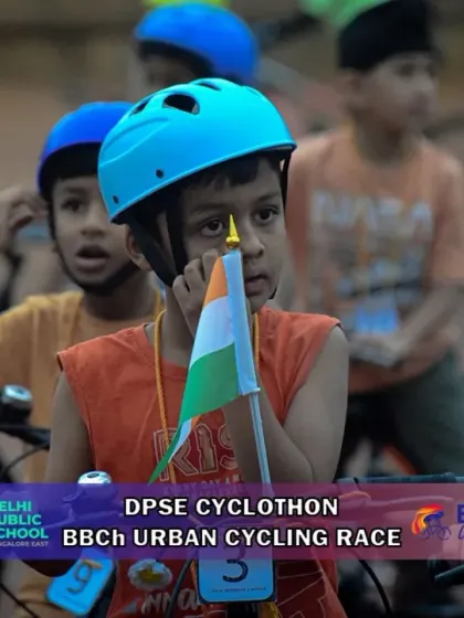 A young patriot ready to race. This little rider holds the Indian flag, showing pride and excitement at the start of the Urban Cycle Race.