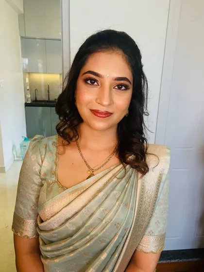 The final result for Mahima's home ceremony. A soft, glowy makeup look with gentle curls that feels elegant and effortless.