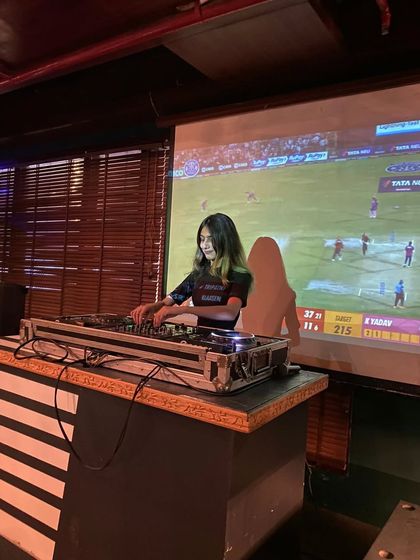 Sometimes the gig involves keeping an eye on the cricket score too. Here I am mixing tracks during a live match screening.