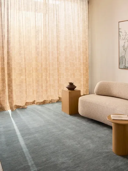My custom-designed sheer curtains filtering sunlight with a gentle warmth. The delicate motifs add an ethereal glow, creating a quiet celebration of nature and tranquility in this minimalist space.