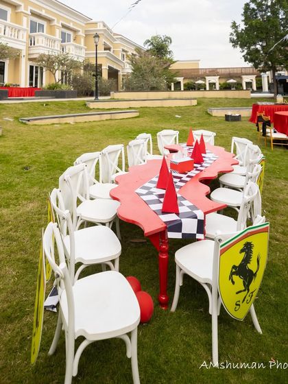 Another view of the custom-shaped, race-track-themed dining table set up on the lawn for the Ferrari party.