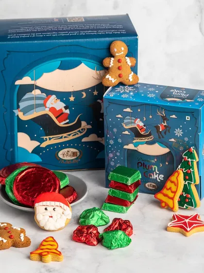 Our 'Jingle Bell Feast' hamper is packed with a wide assortment of our Christmas specials, including cake, cookies, chikkis, and biscuits.