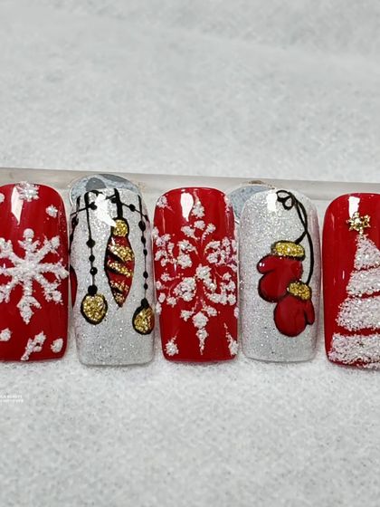 Witness the magic our students create with these classic red and white Christmas nails, featuring snowflakes, ornaments, and a sweater texture.