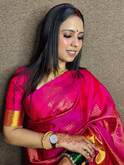 A simple and elegant look for a client in a bright pink saree. The makeup is minimal and fresh, perfect for a daytime event.