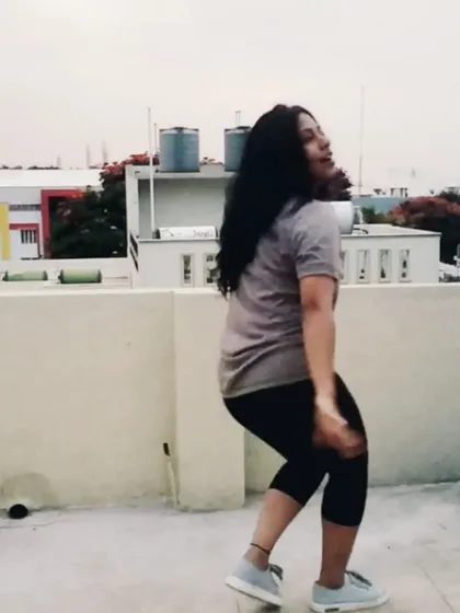 We also love to groove to modern beats. This shot captures a moment from a freestyle practice session on a rooftop, blending Western dance moves with a fun, urban vibe. Our freestyle classes are all about exploring movement and musicality.