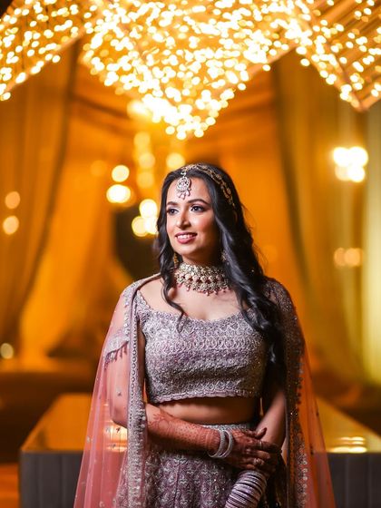 A smile is the best makeup a girl can wear, especially after getting her makeup perfectly done. This shot captures the elegance of her party look under beautiful lighting.