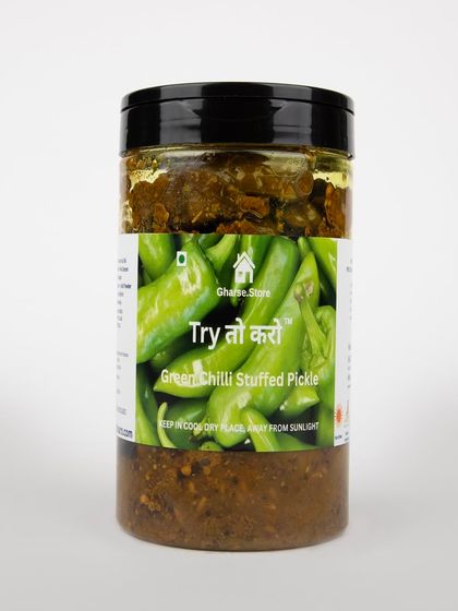 A larger jar of Green Chilli Stuffed Pickle, isolated on white.