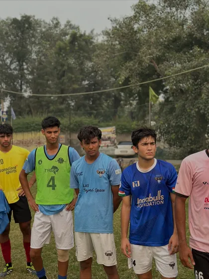 Players listening intently during a training session. Discipline and focus are core values we teach at our academy.