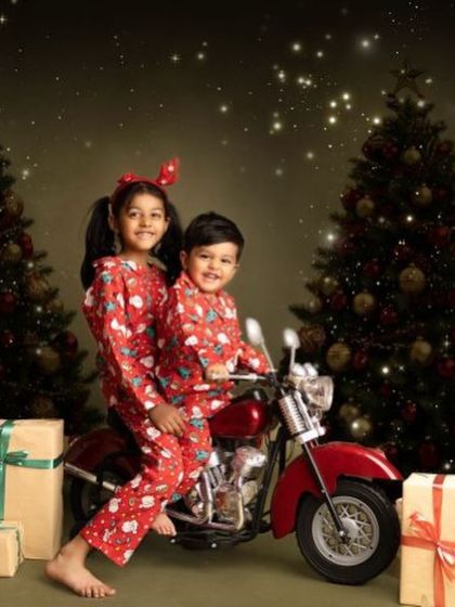 A fun and unique Christmas shot with siblings in matching pajamas on a miniature motorcycle. I love incorporating creative props to make holiday photos extra special.