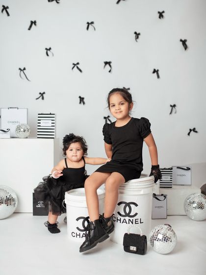 A full-length view of the creative 'Chanel' themed sibling shoot. I provide styling and props to make your child's photoshoot extra special.