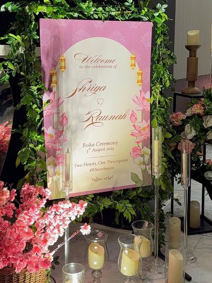 The first impression matters. We designed this custom welcome sign for Shriya and Raunak's Roka, framed with lush greenery and surrounded by candles to create a warm and inviting entrance.