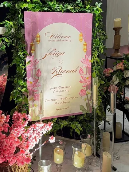 The first impression matters. We designed this custom welcome sign for Shriya and Raunak's Roka, framed with lush greenery and surrounded by candles to create a warm and inviting entrance.