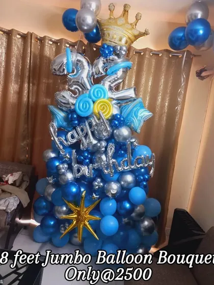 This is an example of my 8-foot jumbo balloon bouquets, perfect for making a big statement. This one, for a 32nd birthday, uses a stylish blue and silver chrome theme with a large crown foil balloon.