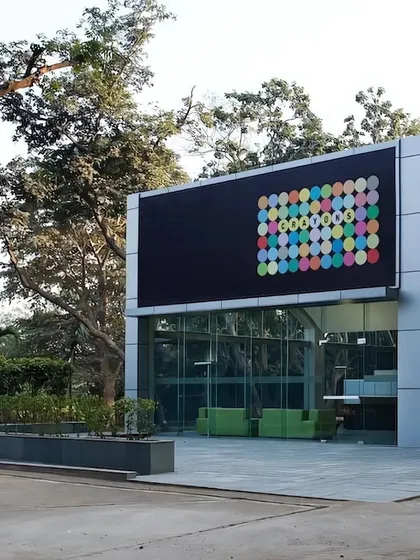 A frontal view of the transformed workplace highlights the new glass entrance, which invites light and views into the building. The design proves that with creative vision, even a forgotten industrial structure can become a vibrant and inspiring place to work.