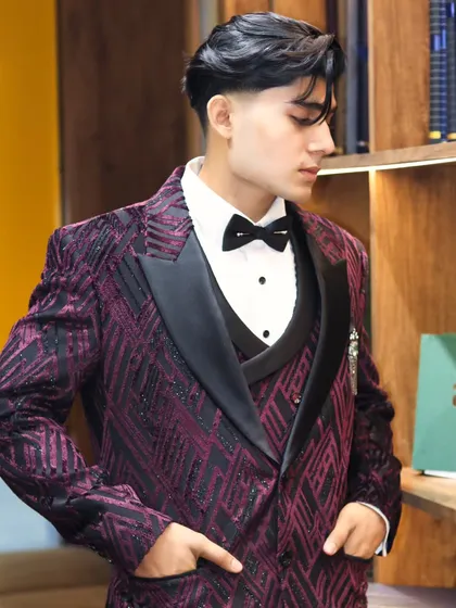 For a client who wants to make an entrance, I designed this custom three piece tuxedo. The deep purple fabric with its unique geometric pattern and black satin lapels is for the man who isn't afraid of bold style.
