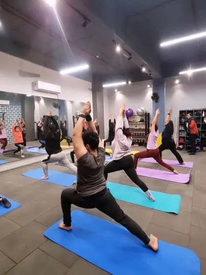 It's not all high-intensity, all the time. We balance the hard work with mindful movement. Our group yoga sessions, like this one, focus on improving flexibility, releasing tension, and connecting your mind and body.