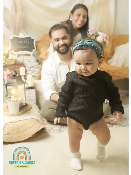 A baby's first steps are a huge milestone. We captured this little one on the move while mom and dad watch with pride in the background.
