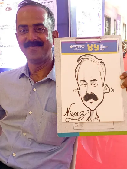 Here is a happy visitor from a public event I did for the Sakal Media Group in Kolhapur, holding his new caricature.