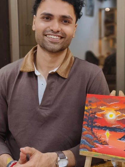 Another proud artist from our canvas painting workshop. Our step-by-step guidance ensures that everyone, regardless of skill level, can create a piece of art they love.