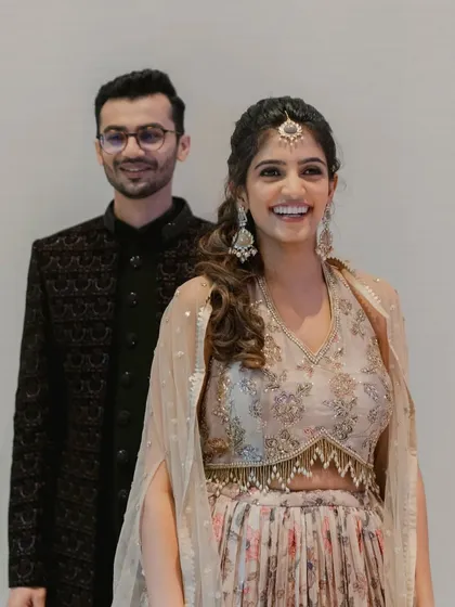 The happy couple. Her makeup is fresh and radiant, perfect for a night of dancing and celebration.